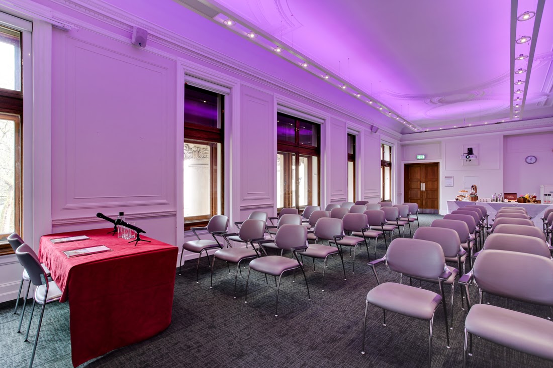 Event space at One Birdcage Walk with purple lighting for presentations and seminars.
