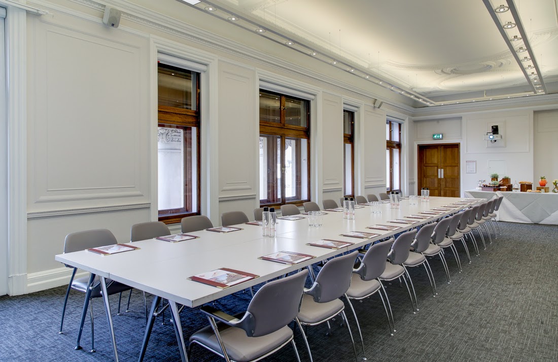 Professional meeting room with long table, ideal for workshops and board meetings.
