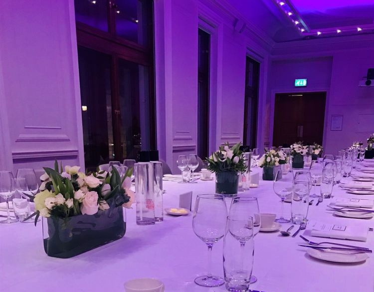 Elegant dining table with floral centerpieces for a corporate gala at One Birdcage Walk.