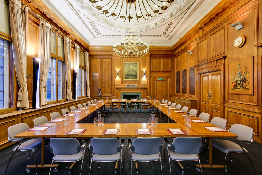 Sophisticated meeting room with wooden paneling, ideal for corporate events and brainstorming.