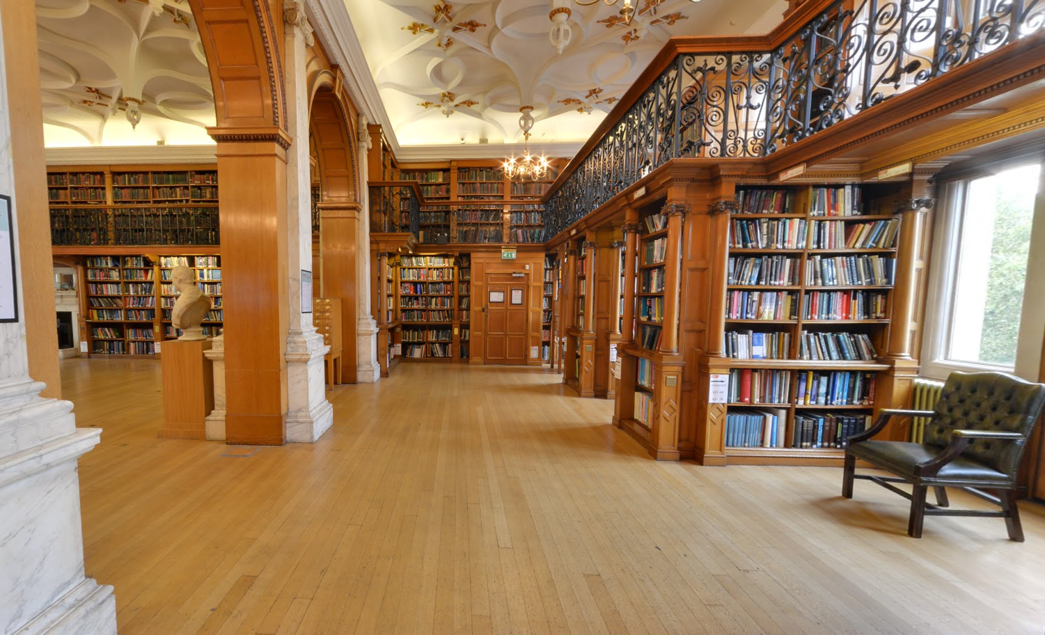 Elegant library with warm wood tones, perfect for intimate meetings and workshops.