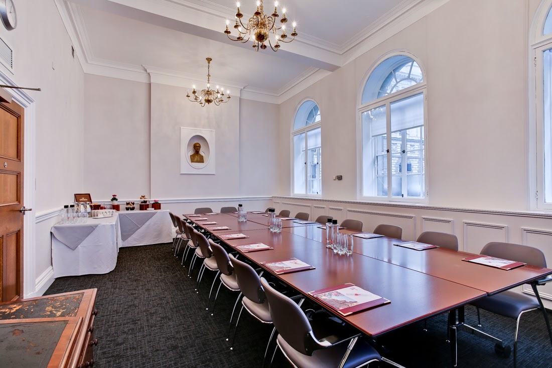 Elegant meeting room with long table, ideal for corporate events and gatherings.