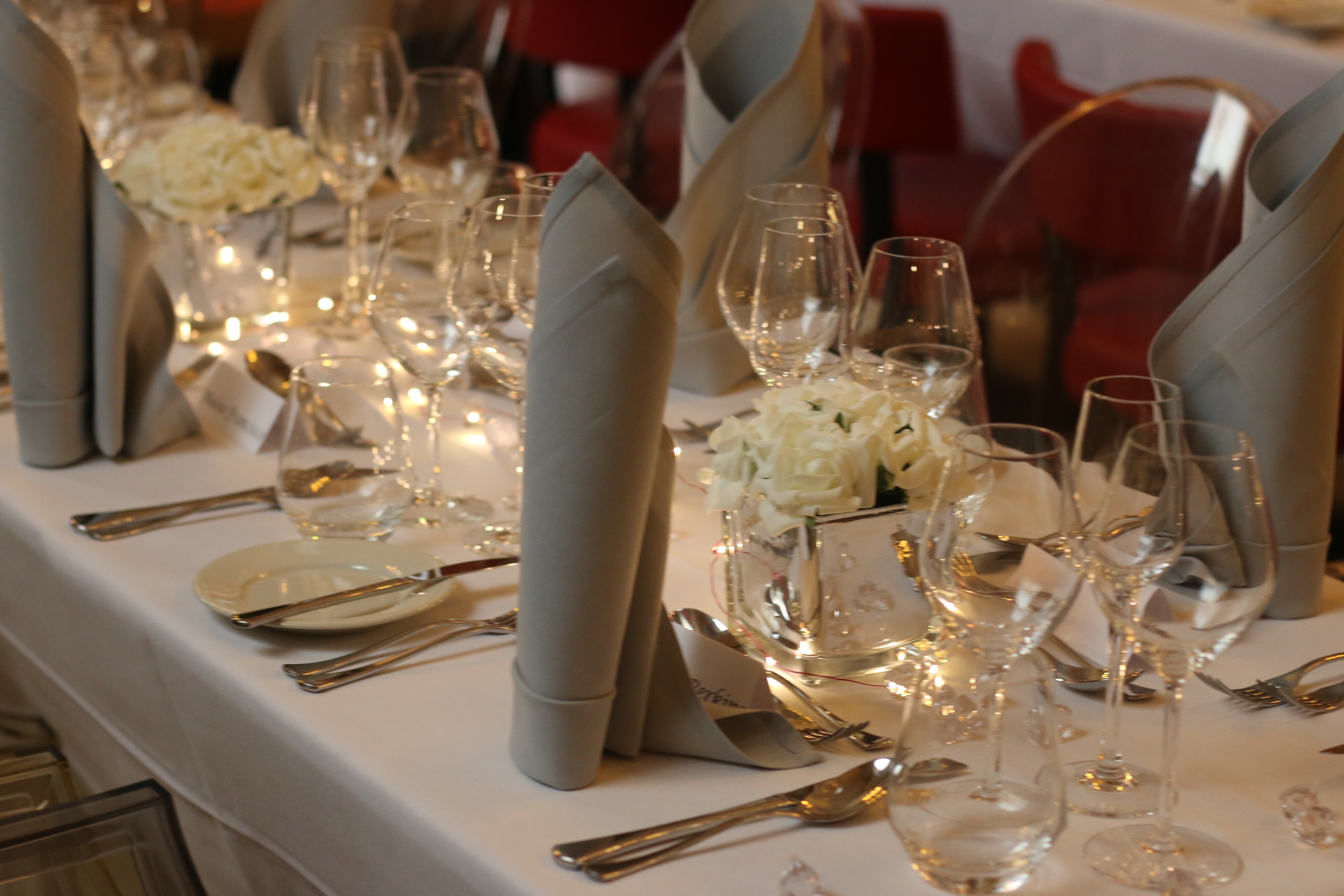 Elegant dining table with white flowers at Boyds Grill & Wine Bar for formal events.