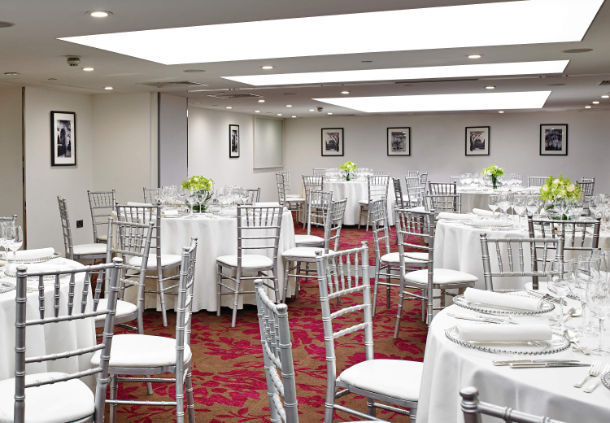 Mayfair Suite at London Marriott: elegant event space with round tables and soft lighting.