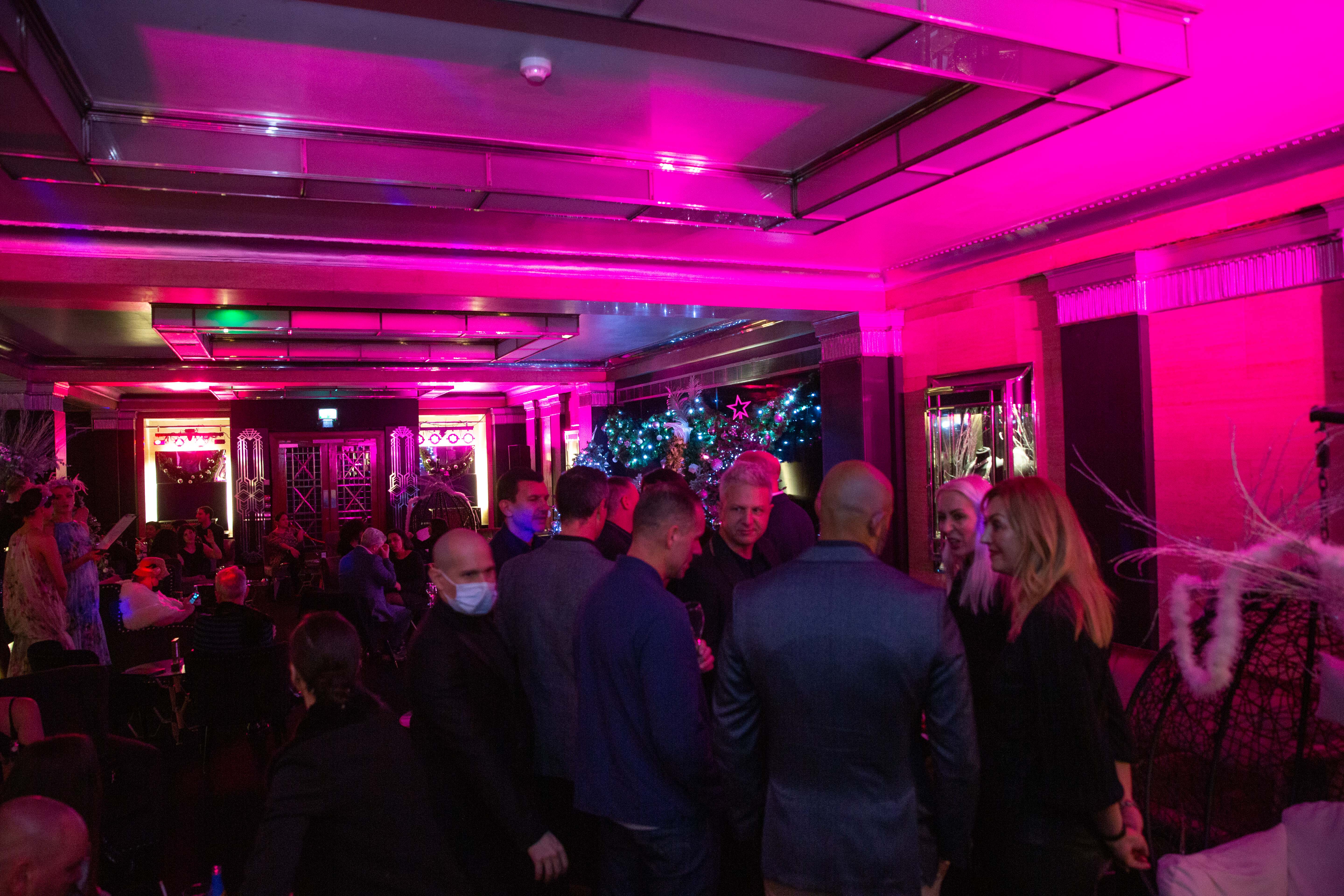 Vibrant Rose Bar event space with pink lighting for networking and themed events.