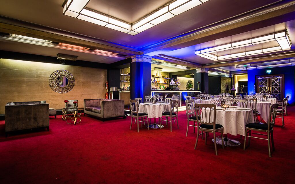 Elegant Rose Bar event space with round tables, ideal for corporate meetings and celebrations.