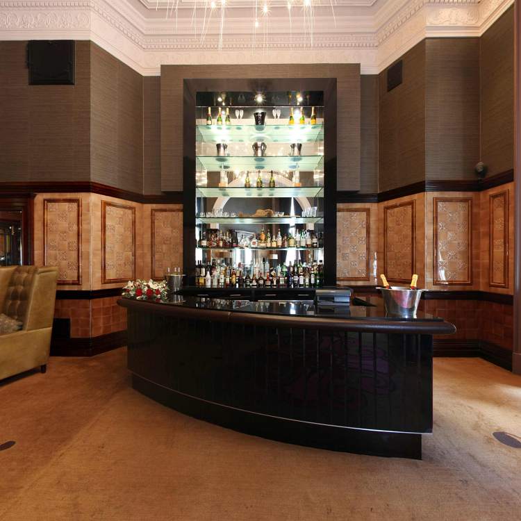 Churchill's Bar at The Royal Horseguards Hotel, sleek black counter, ideal for cocktail receptions.