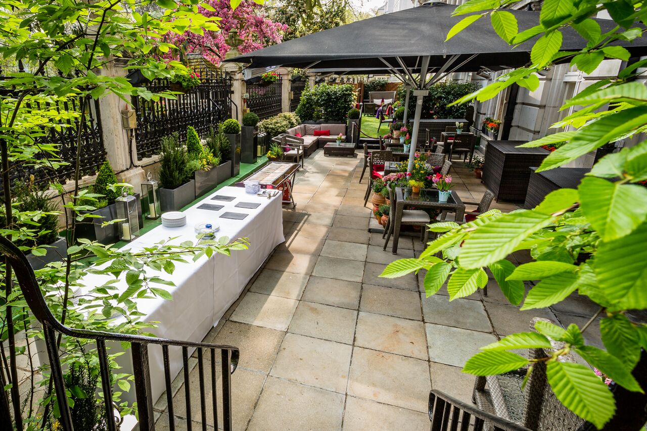 Outdoor event space at The Royal Horseguards Hotel with elegant seating and greenery.