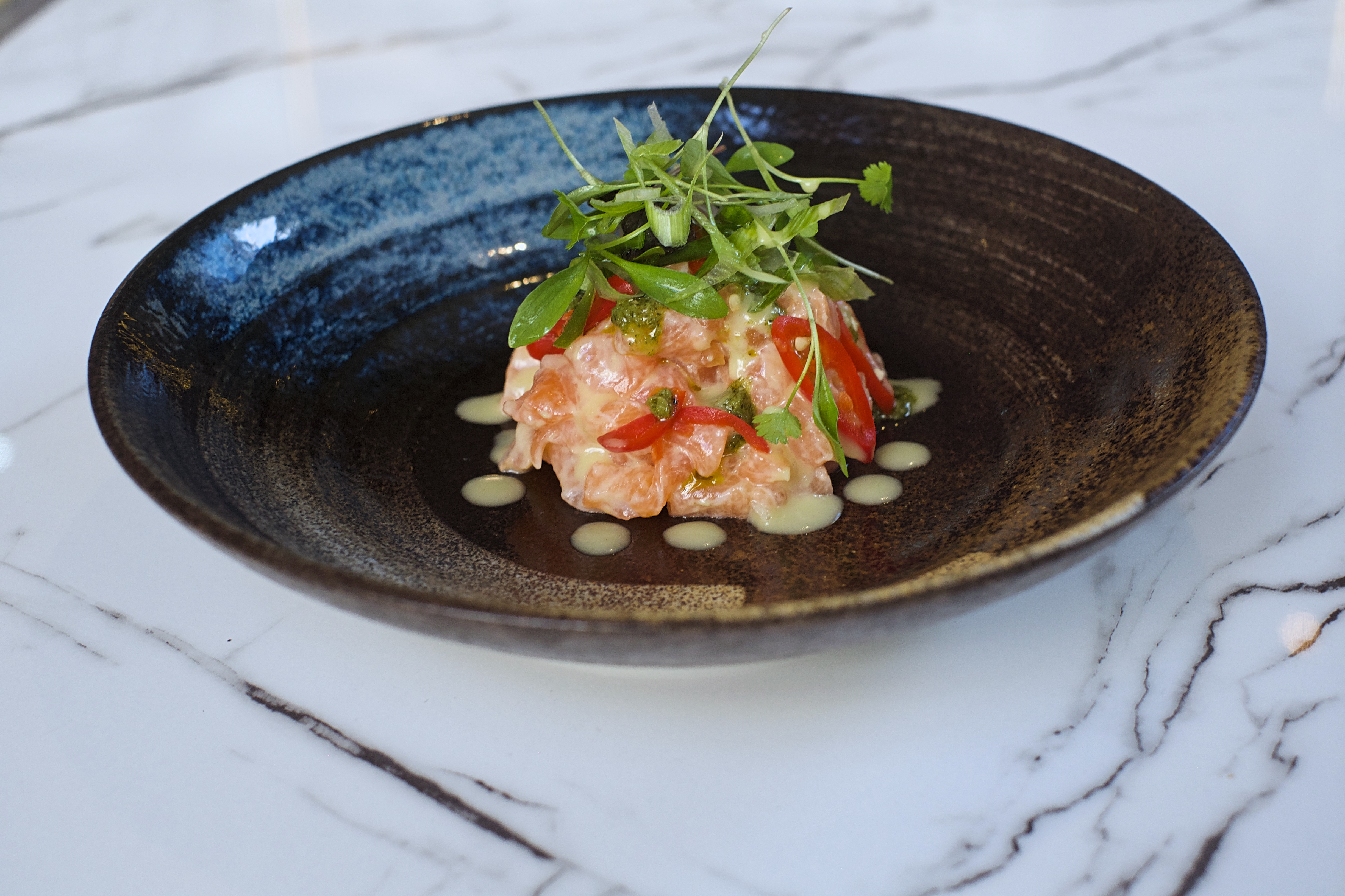 Seafood tartare with microgreens at Wild Heart Bar, upscale dining in Soho.