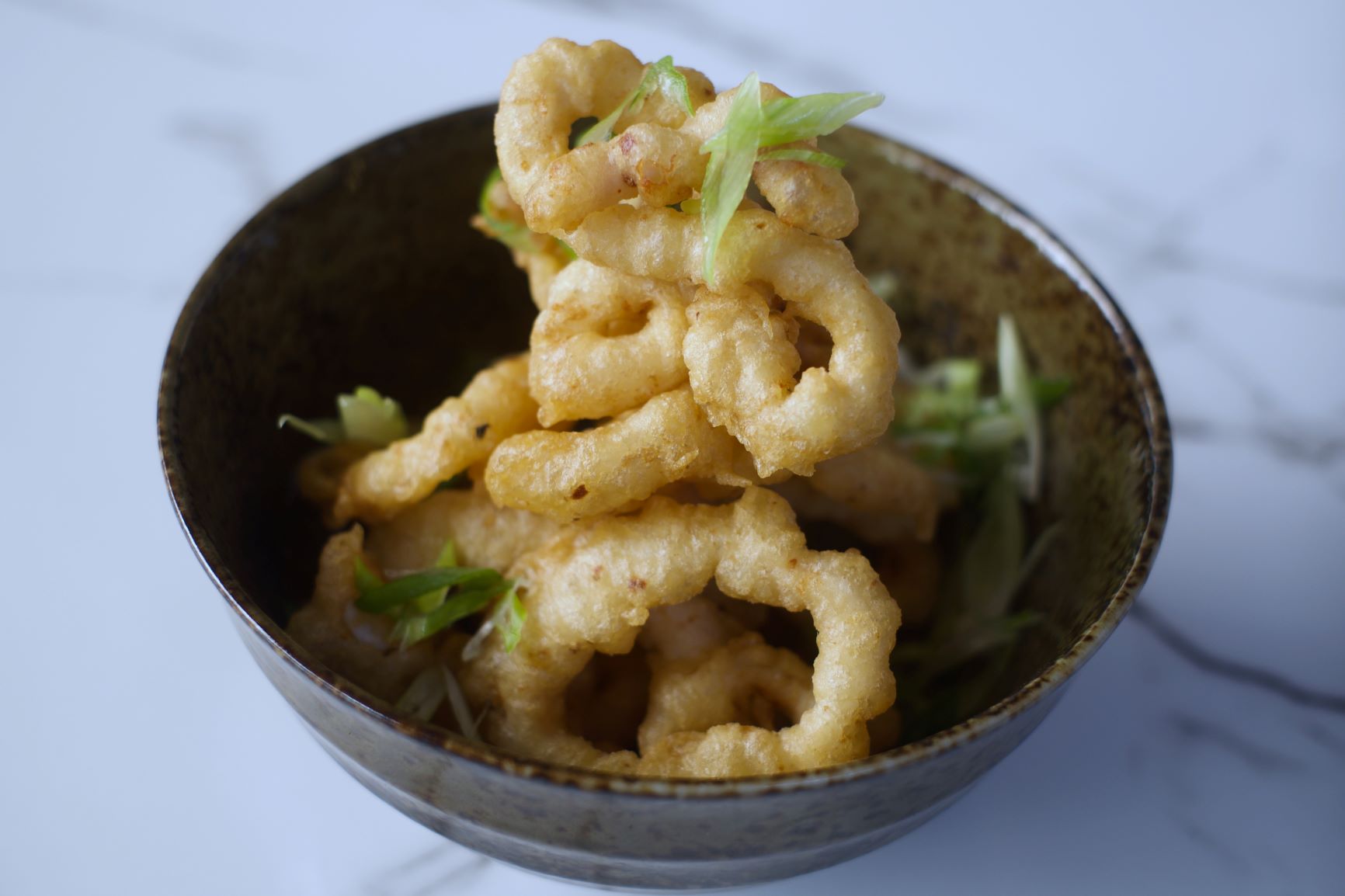 Crispy fried calamari appetizer at Wild Heart Bar, perfect for upscale events.