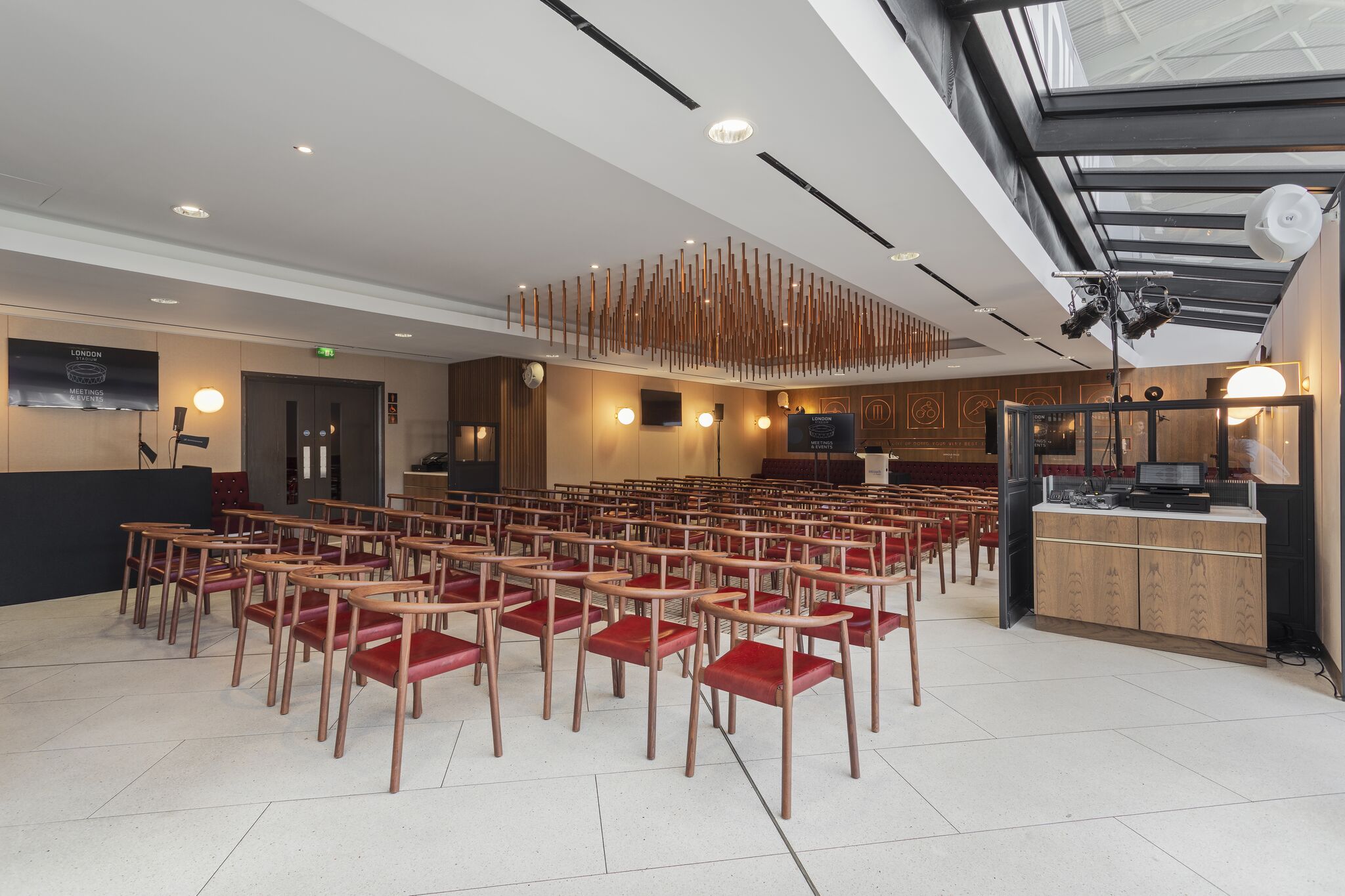 Modern meeting space in London Stadium with wooden chairs for tech-driven events.