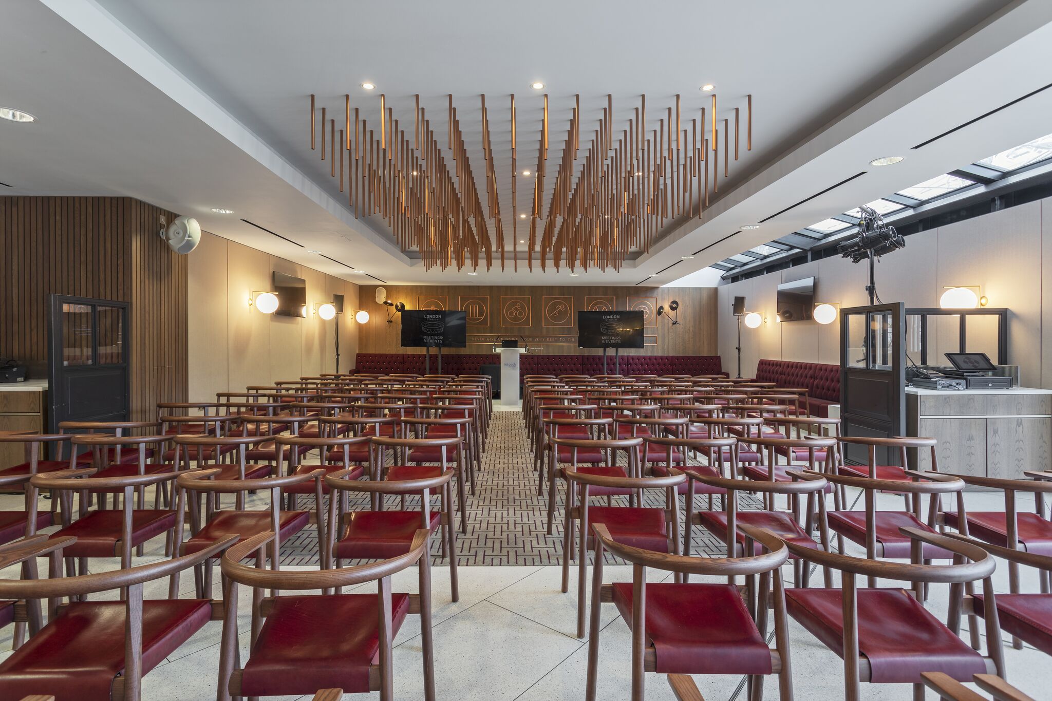 Arnold Hills event space in London Stadium with wooden chairs, ideal for workshops and presentations.