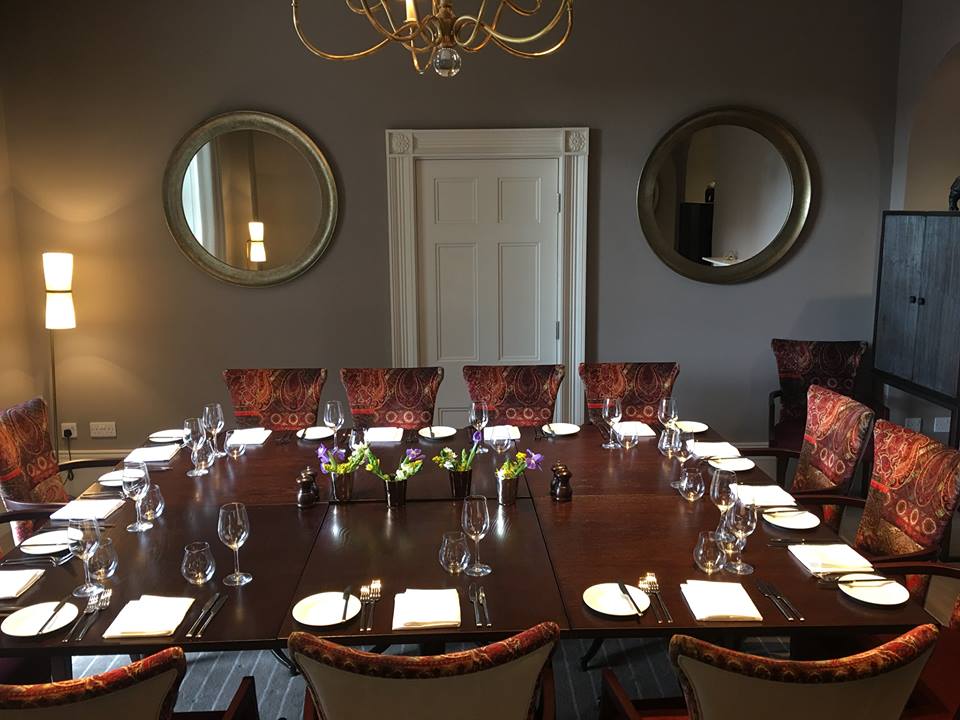 Elegant meeting room with fine china, perfect for corporate events and gatherings.