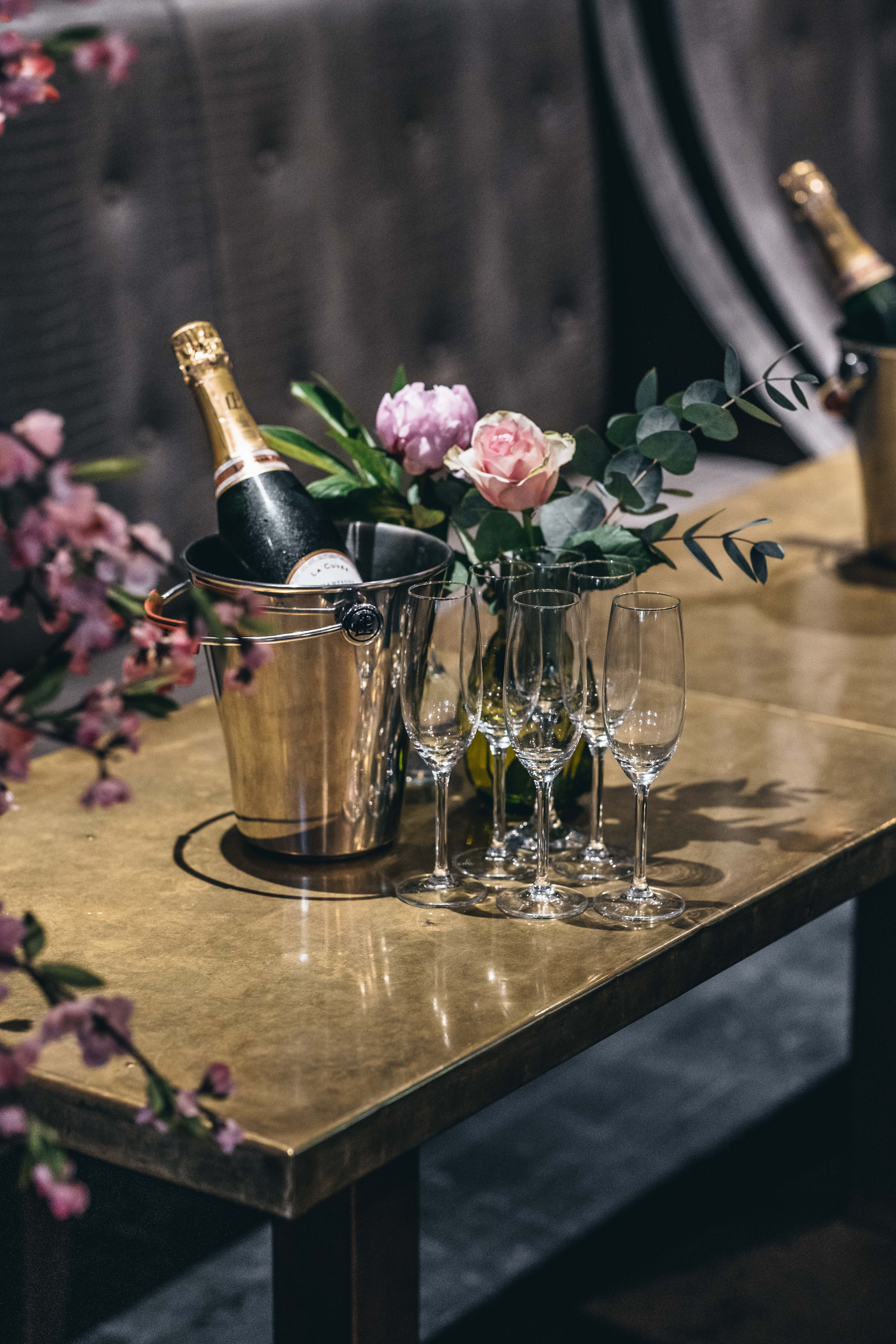 Elegant Inner Sanctum bar setup with champagne and floral accents for celebrations.