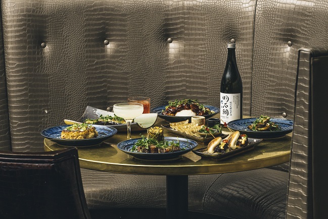 Elegant dining table with gourmet dishes at Karma Sanctum Soho for upscale events.