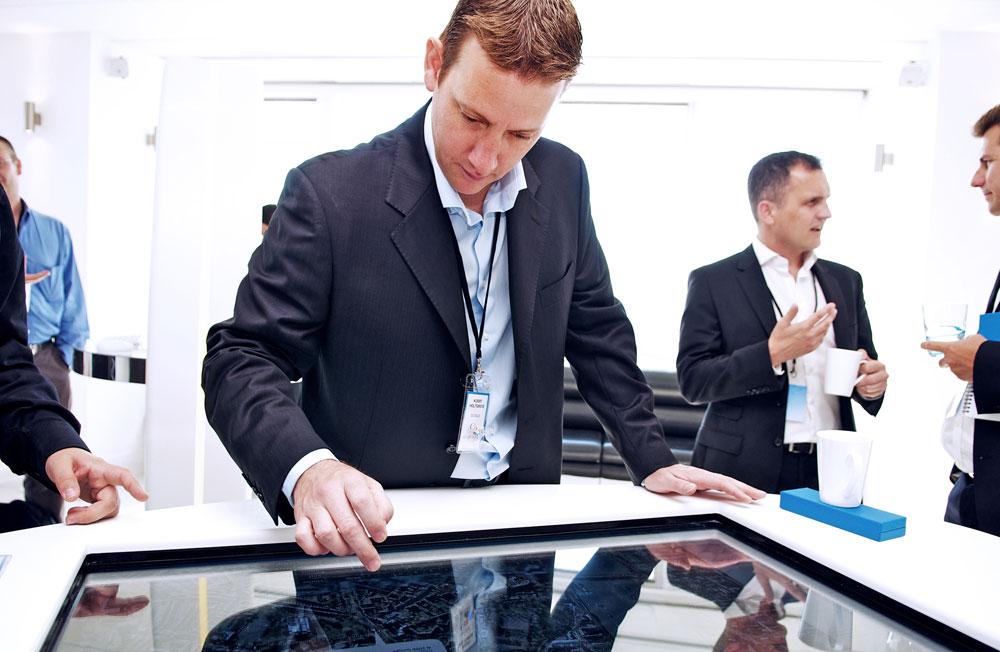 Professional using interactive display at Altitude 360, perfect for tech events and networking.