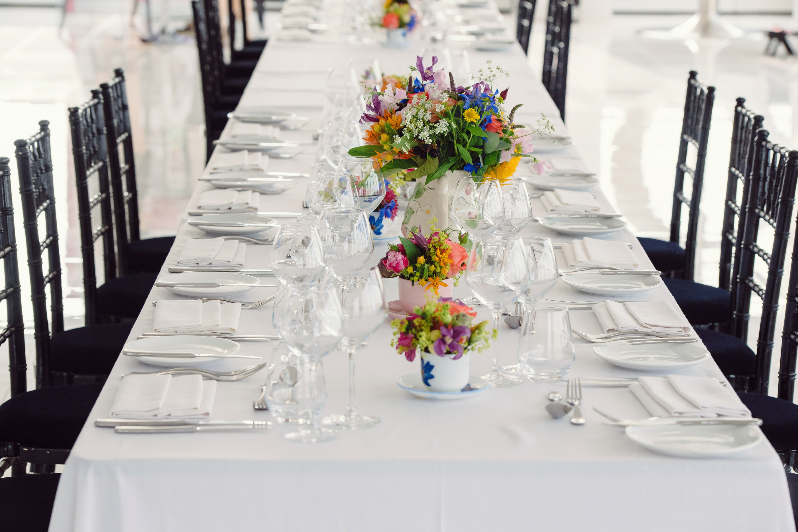 Elegant banquet table with floral arrangements for upscale weddings and events.