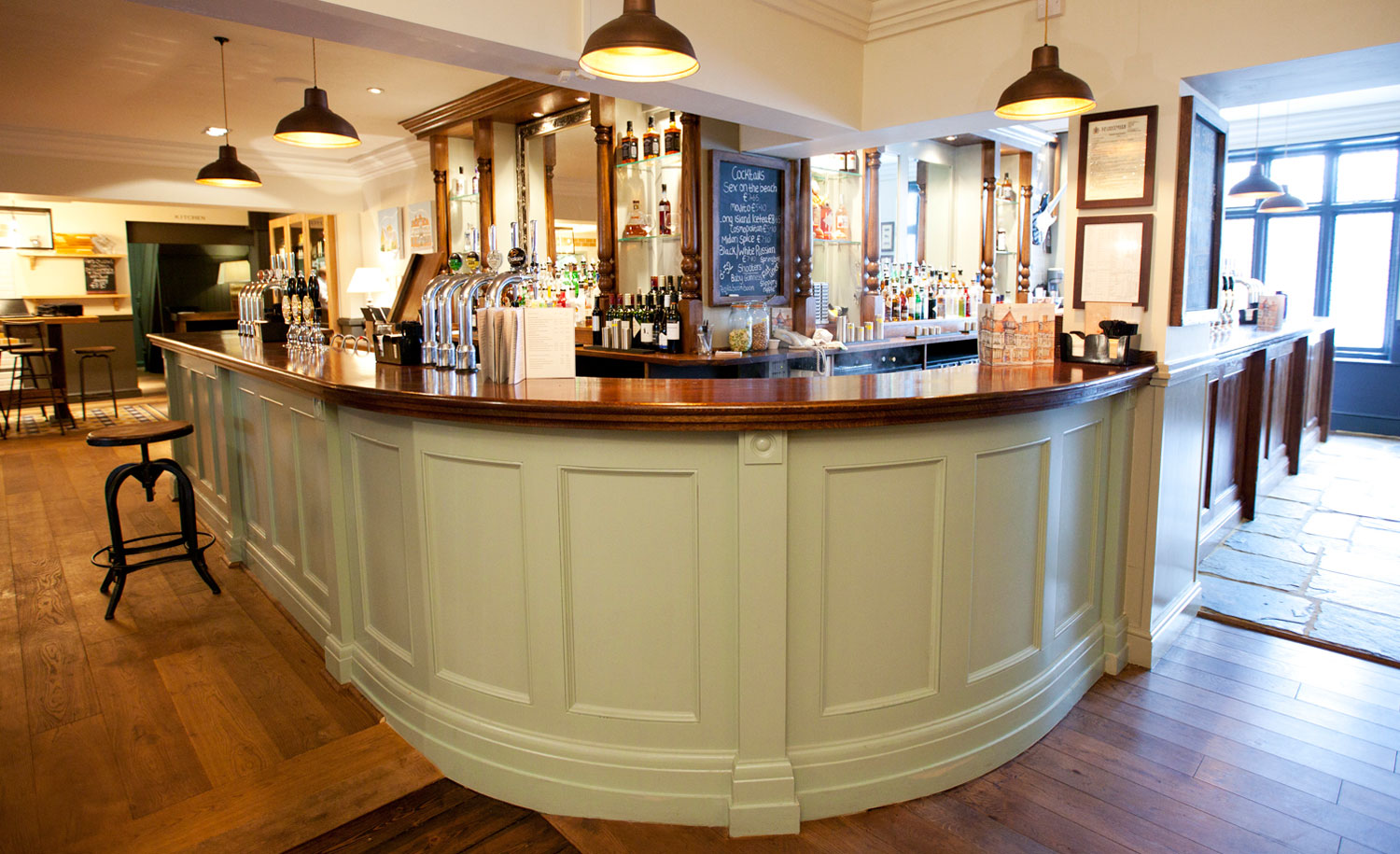 Polished wooden bar at The Crown Hotel, ideal for professional networking and cocktail receptions.
