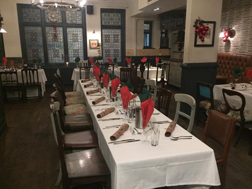 Old Bar festive holiday dining setup with banquet tables for private events.