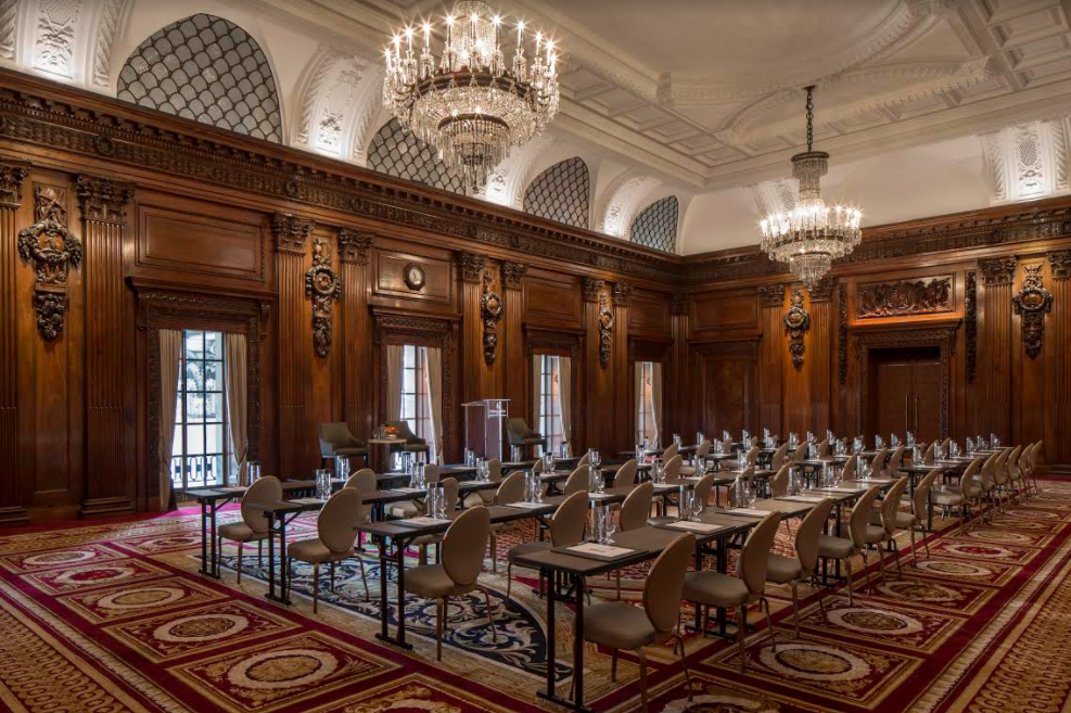 Elegant meeting room with wood paneling, ideal for corporate events and presentations.