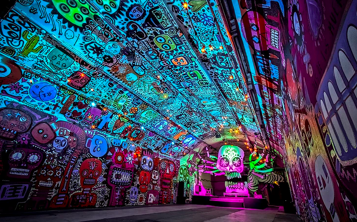 Vibrant event space with murals, ideal for themed gatherings and creative events.