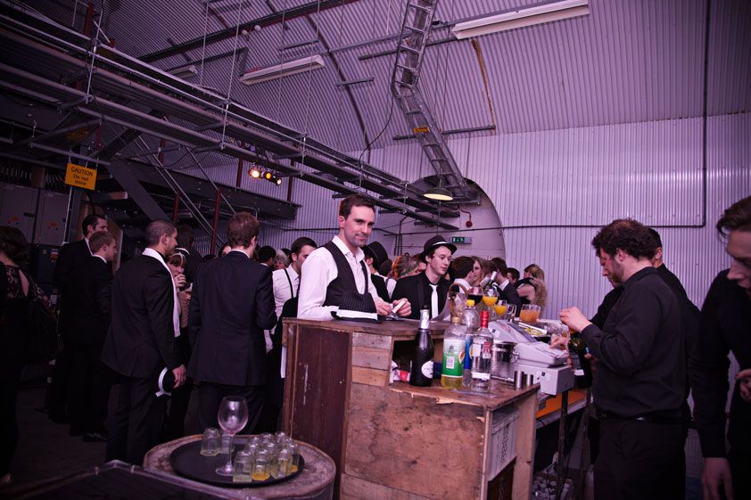The Mezzy One event in The Vaults, featuring a lively bar and formal attire.