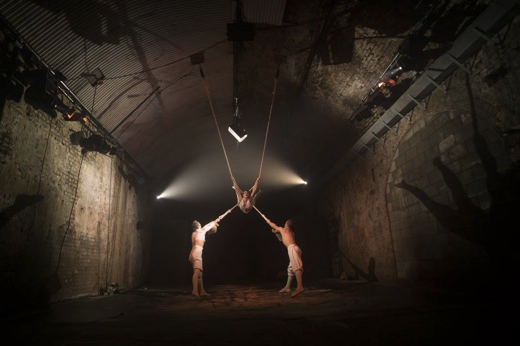 Aerial performance in The Vaults' unique event space with dramatic lighting.