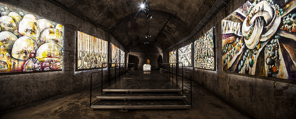 Industrial underground event space with tiered seating for presentations and workshops.