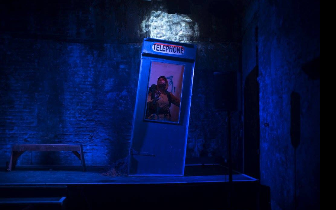 Creative telephone booth with blue lighting in atmospheric event space for immersive experiences.