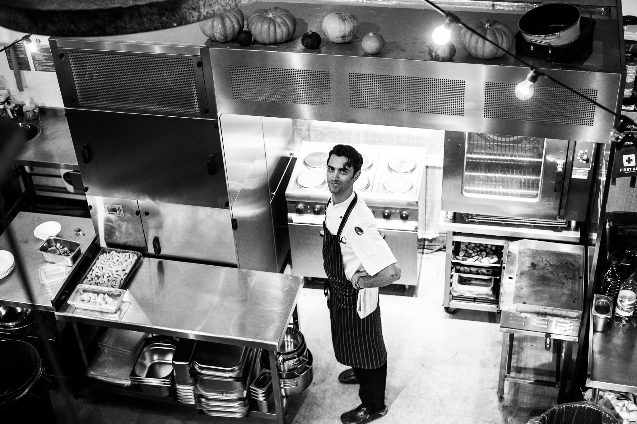 Chef in bustling kitchen at The Food One, showcasing culinary excellence for events.