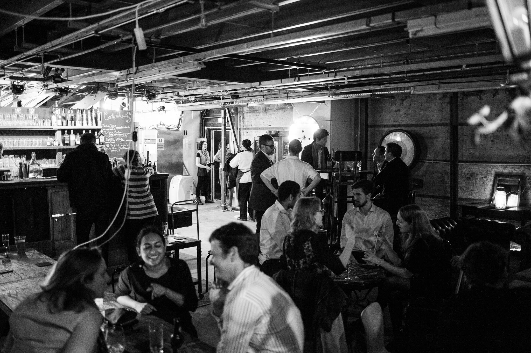 Lively networking event at The Vaults with rustic decor and engaged guests.