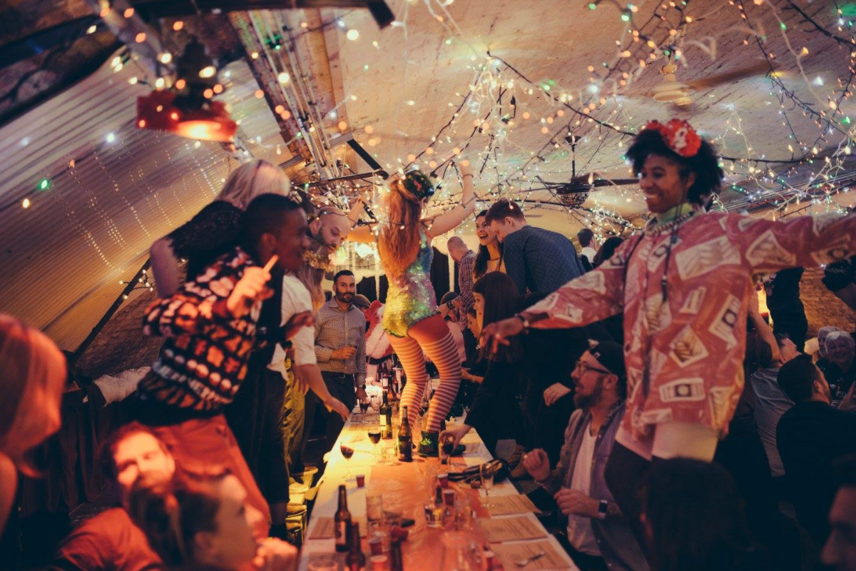 Vibrant party atmosphere at The Food One with guests dancing and festive decor.