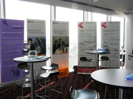 Arc at Wembley Stadium with banners and tables for networking event.