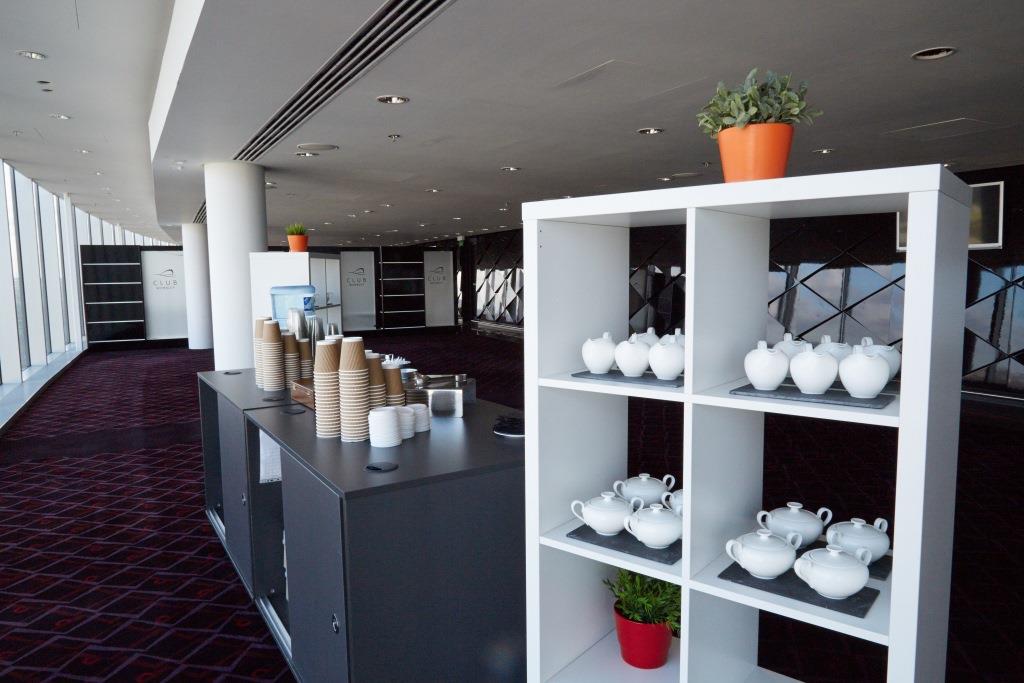 Arc at Wembley Stadium: modern event space with tea sets, ideal for conferences and networking.
