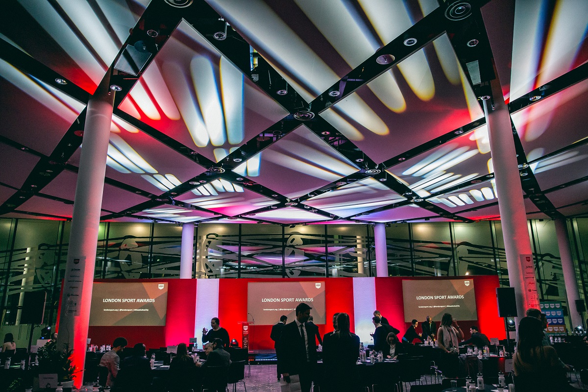 Bobby Moore Room at Wembley Stadium, modern awards ceremony space with dramatic lighting.
