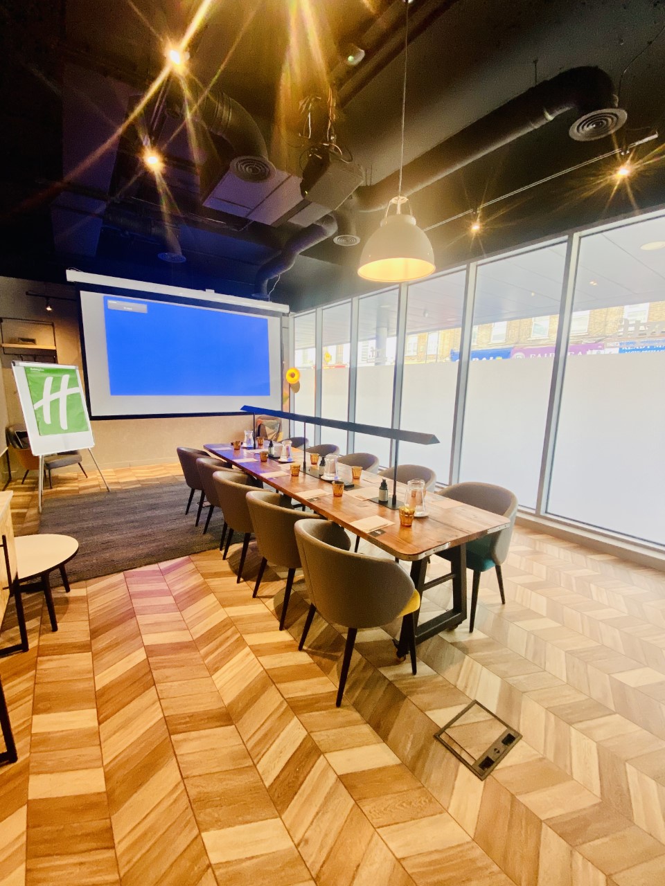 Whitechapel Think Factory meeting room with wooden table, ideal for corporate events.