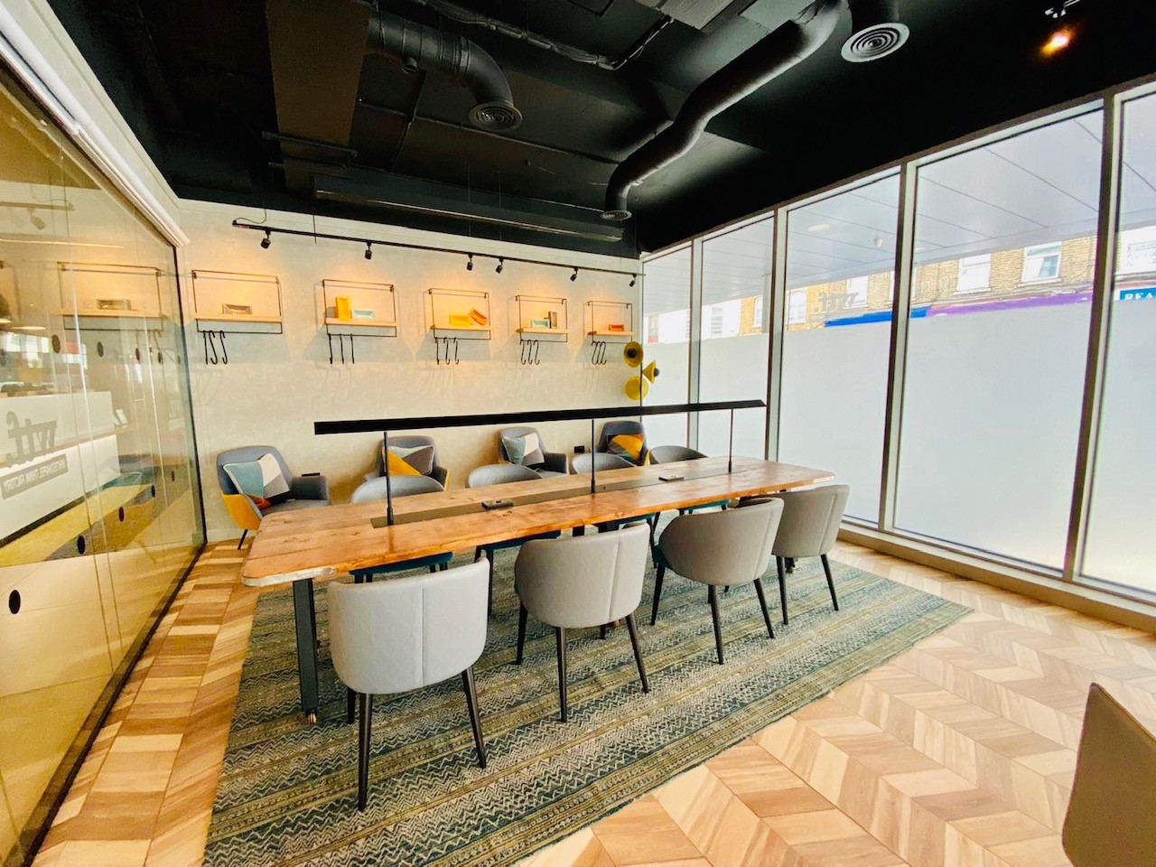 Modern meeting room at Holiday Inn Whitechapel with large wooden table for collaborative events.