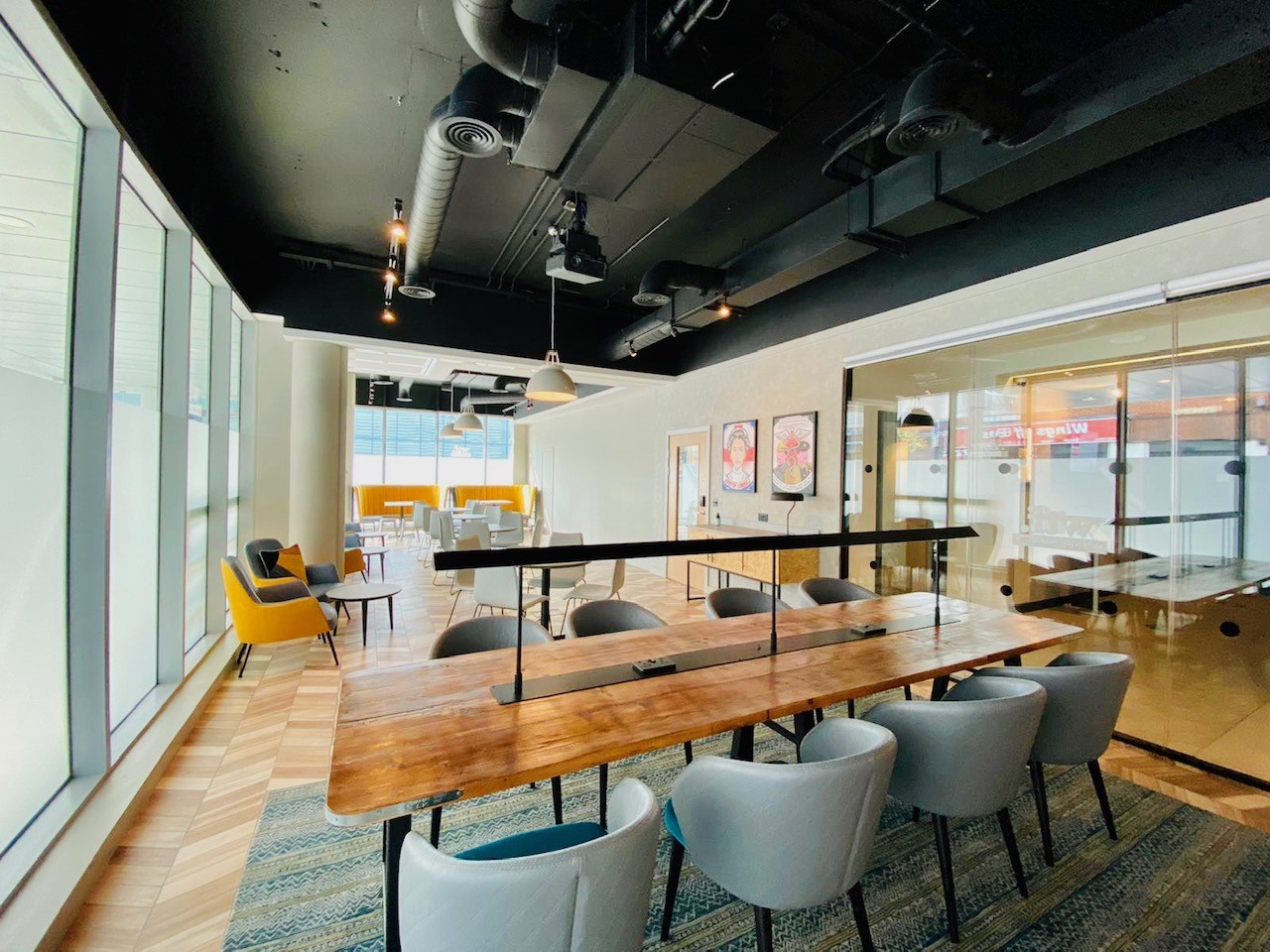 Modern meeting space at Holiday Inn Whitechapel with large wooden table for collaboration.