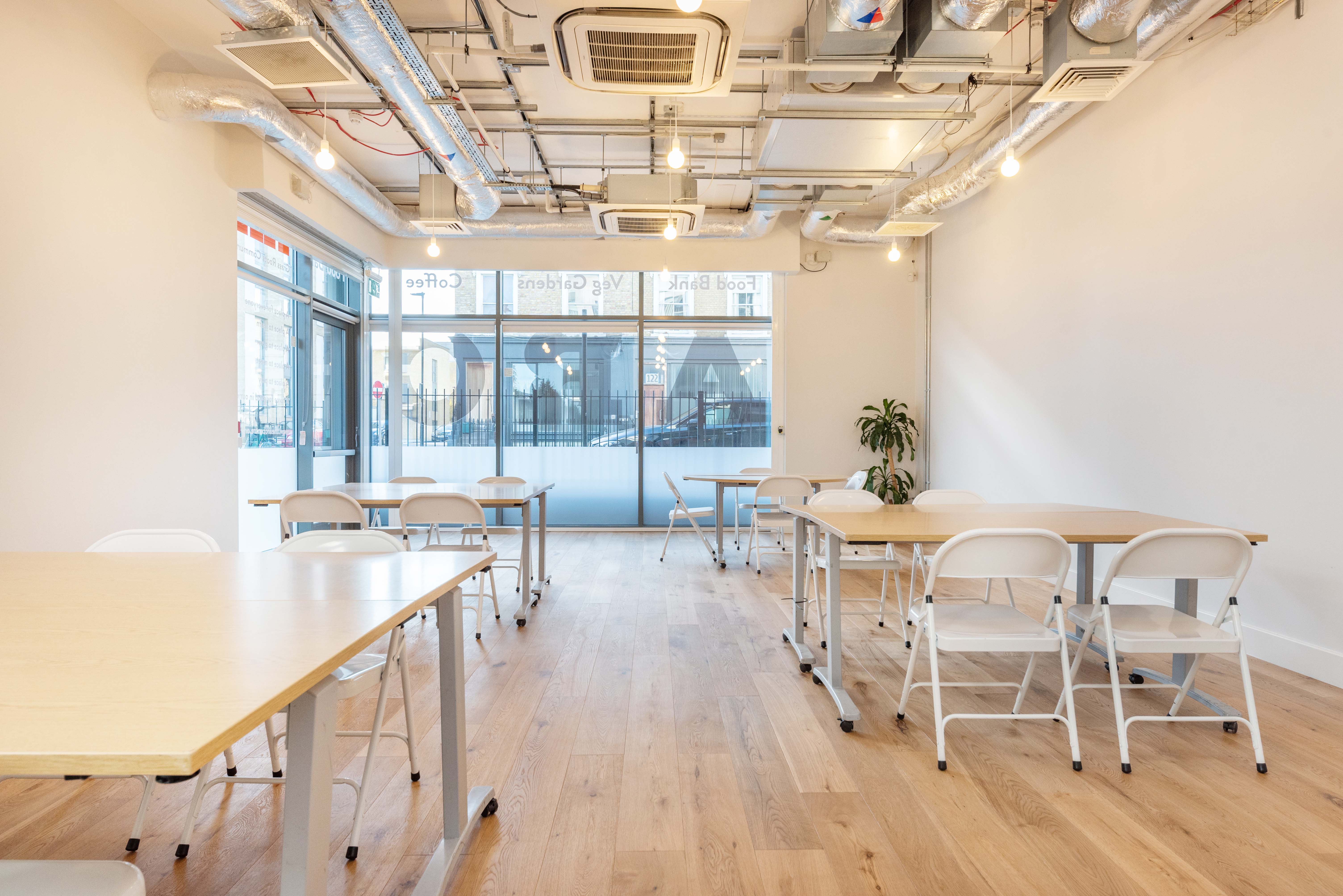 Versatile meeting room with natural light, ideal for workshops and networking events.