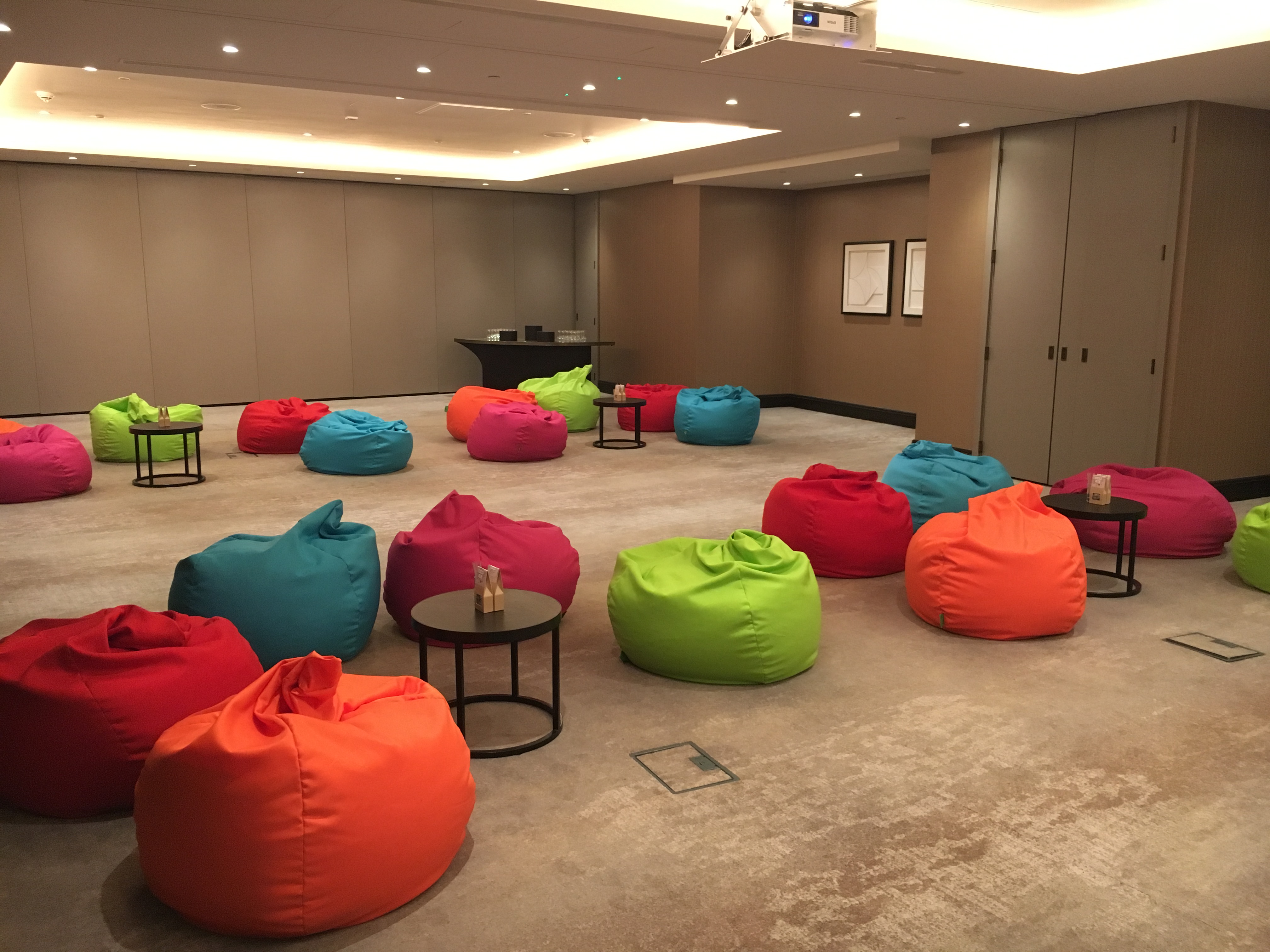 Vibrant Globe Suite meeting space with colorful bean bags for creative brainstorming.
