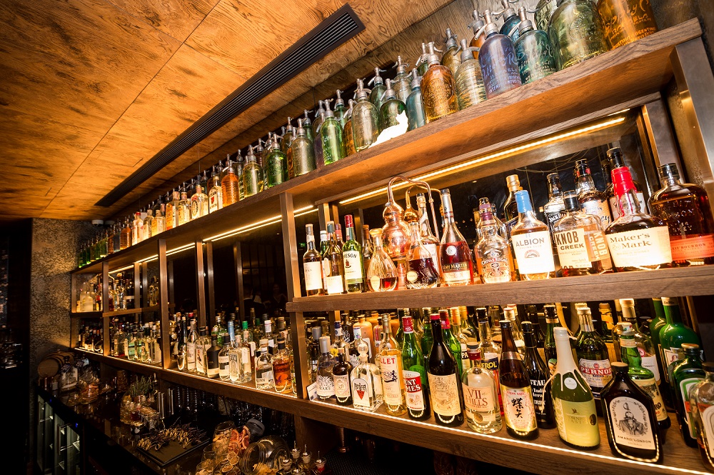 Distillery Bar at Hilton London Bankside, elegant spirits display for events and gatherings.