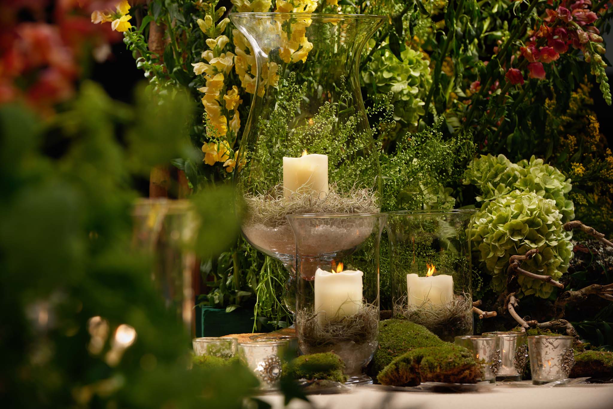 Elegant candle centerpiece with greenery at Hilton London Bankside for weddings and events.