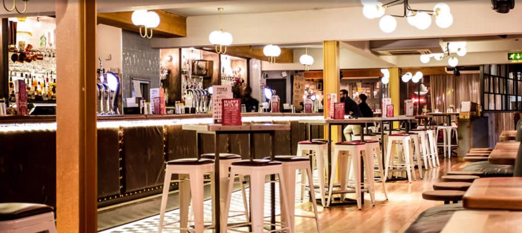 Stylish bar area in Revolution Leeds for networking events and casual gatherings.