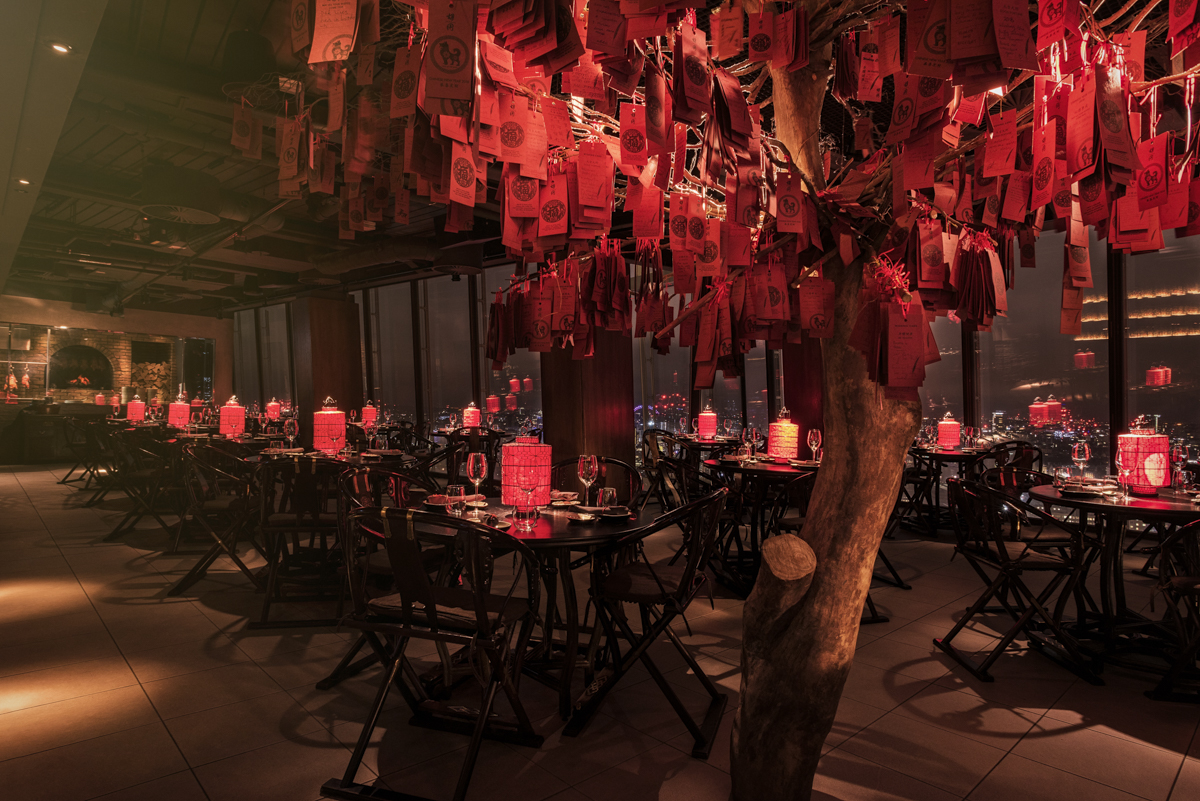Beijing Hutong event space with red-decorated tree, perfect for upscale gatherings.