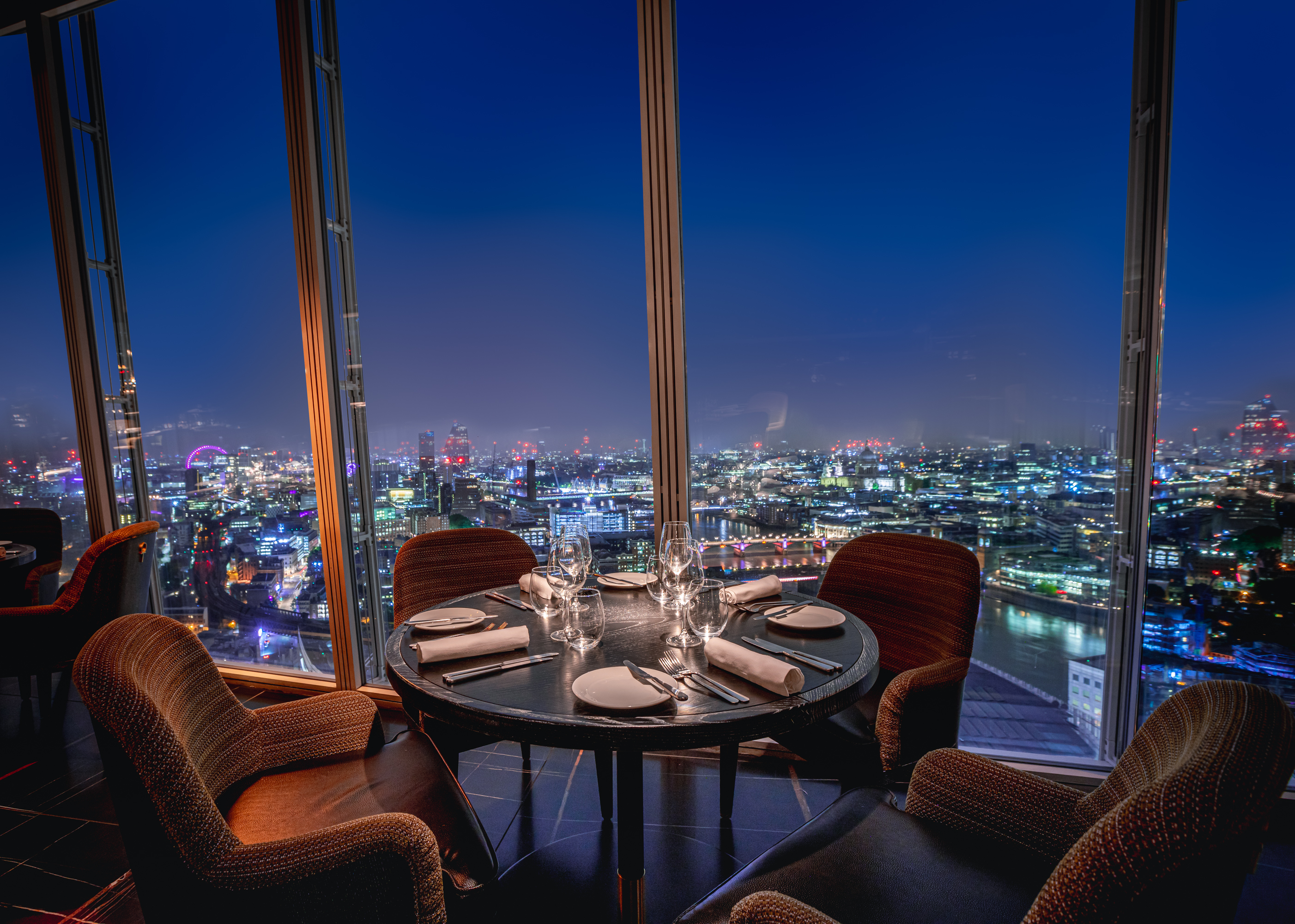 Elegant dining setup at Aqua Shard with city skyline, perfect for corporate events.