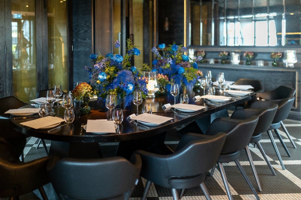 Elegant dining setup at La Casita, featuring blue florals for corporate events.