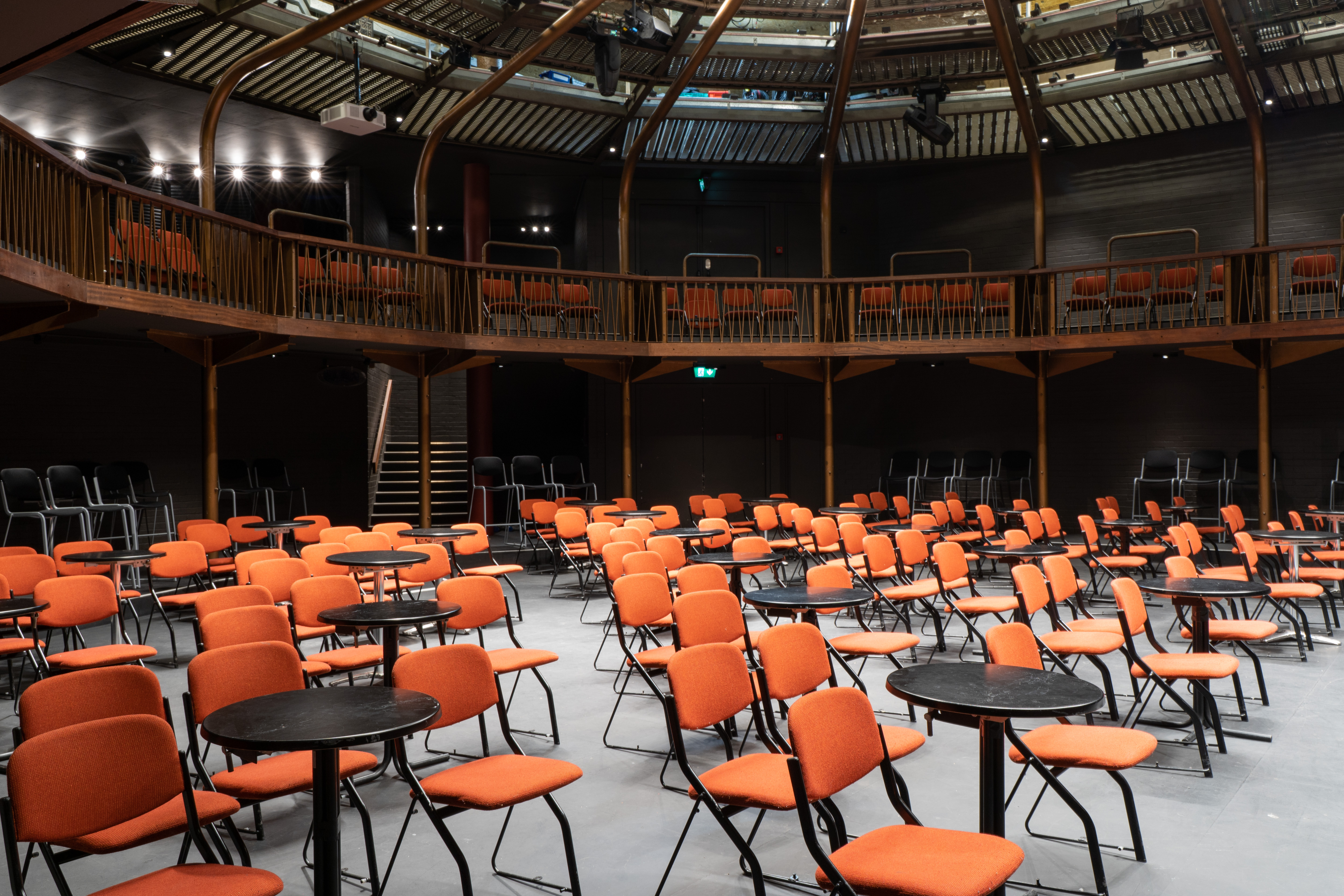 Versatile Theatre in The Albany with orange chairs, ideal for presentations and workshops.