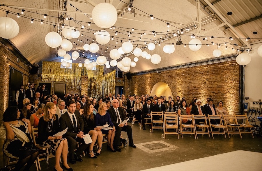 Event space in Shoreditch Studios with warm lighting and rustic brick walls.