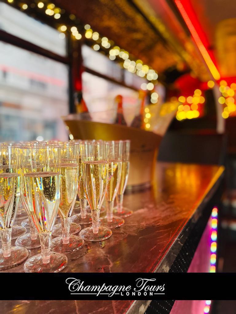 Luxury double-decker bus with champagne flutes for upscale London events and celebrations.