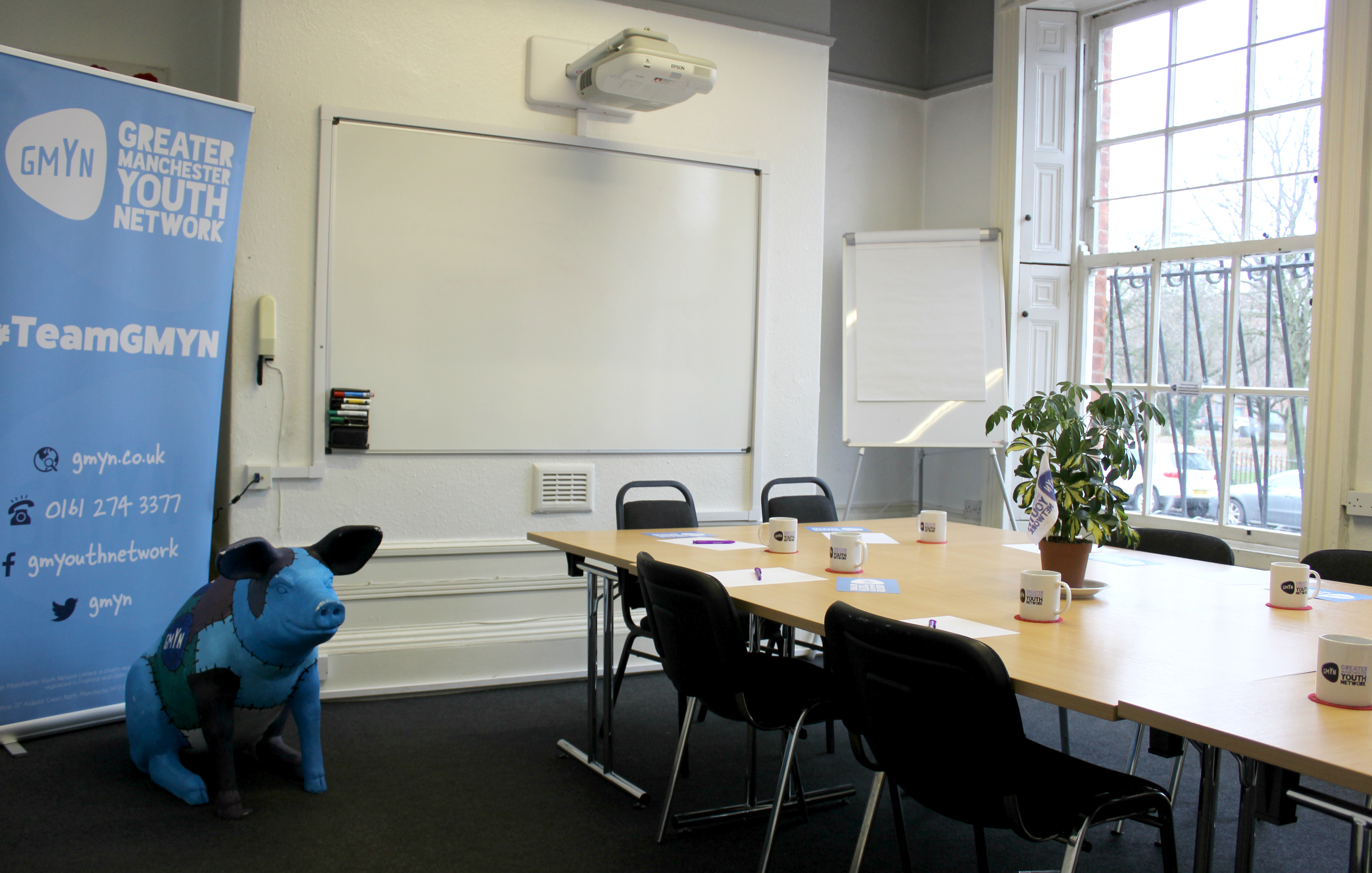 Boardroom in GMYN Offices with large table, ideal for meetings and collaboration.